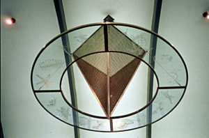 Dallas Area Rapid Transit East End Bus Transfer Station Concept and aesthetic elements were designed by Frances Bagley in conjunction with LAN Engineering and Aguirre and Associates architects. The idea is to reference the ancient history of North Texas and to help with way-finding at the bus station. In the main facility an inverted brass pyramid hangs over a tile inlaid compass rose in the floor. Etched onto the glass ring around the pyramid are fossil images found in the area. All the fossil images are then sandblasted into limestone embeds in the walkways leading to that particular bus shelter. At each shelter the designated fossil reapperas in the glass of the windscreen.